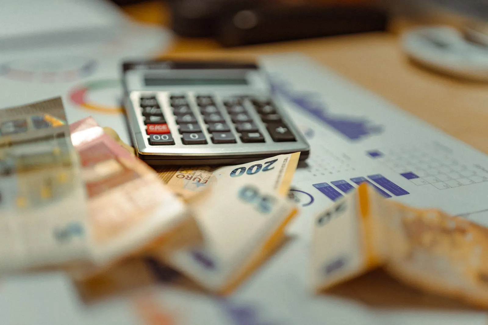 Euro banknotes and calculator on financial documents