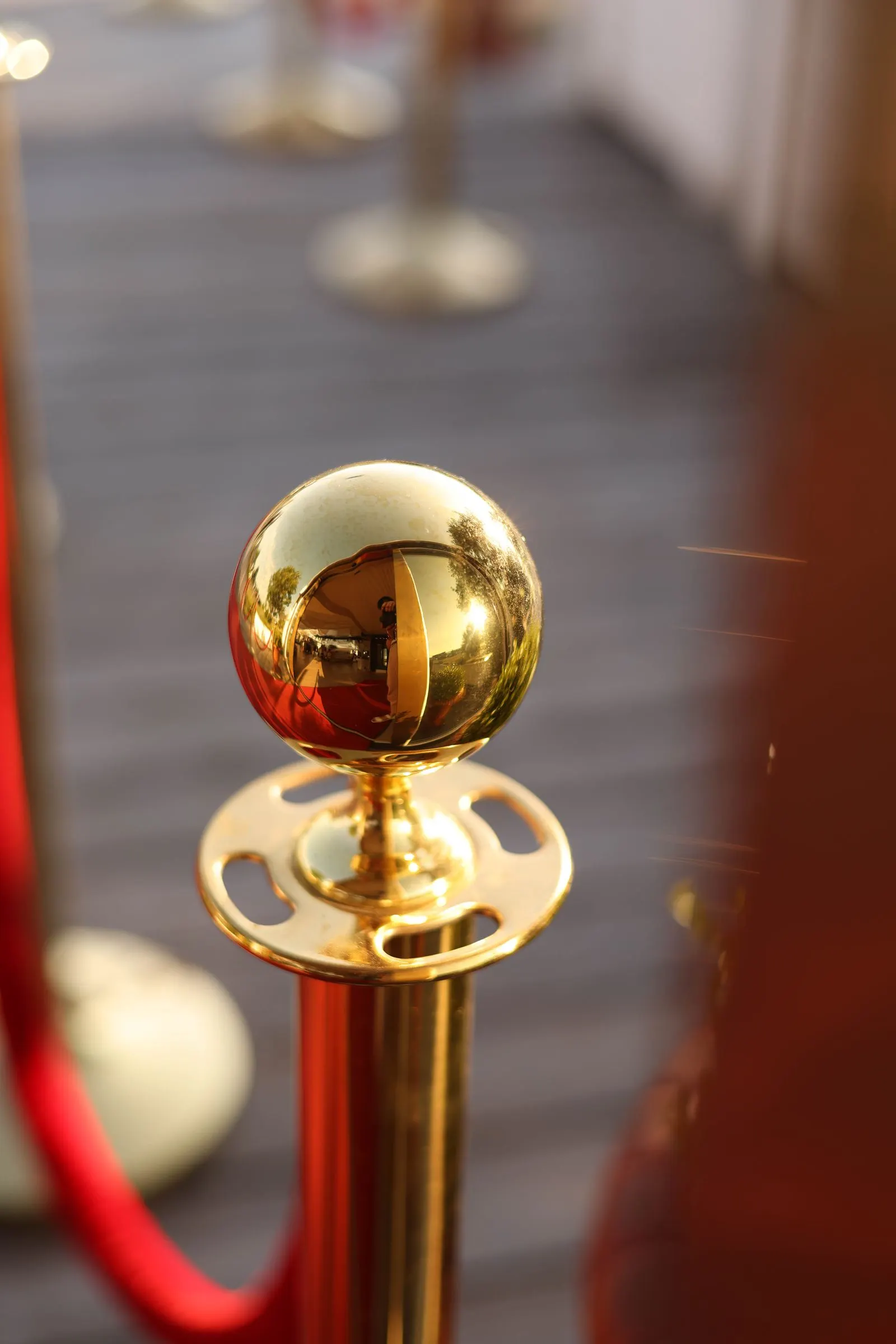 Golden stanchion with a red rope